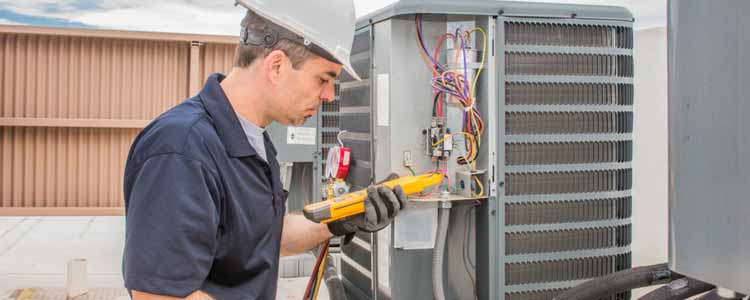 Tech repairing AC unit