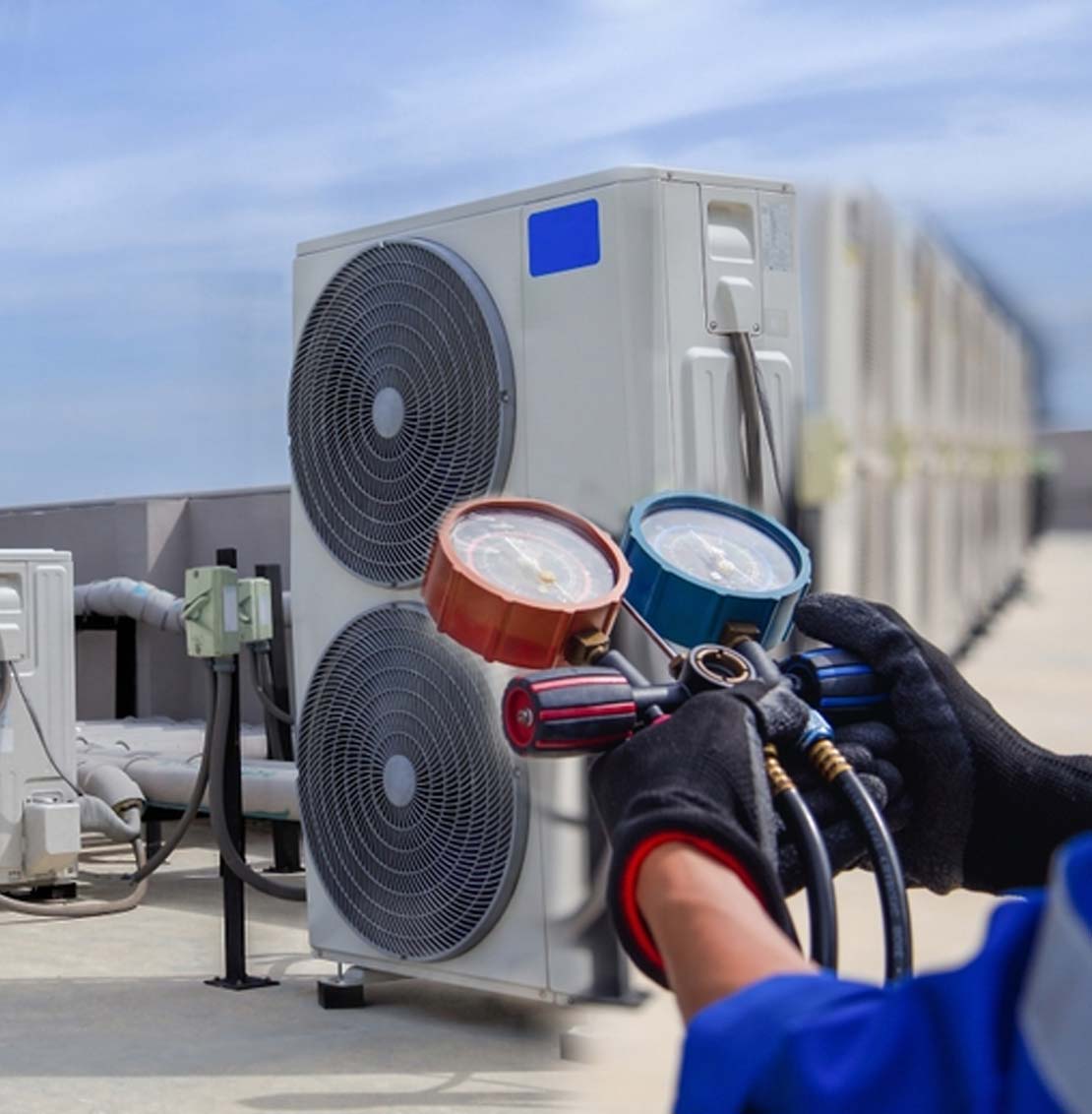Tech looking at HVAC instrument reading on commercial roof